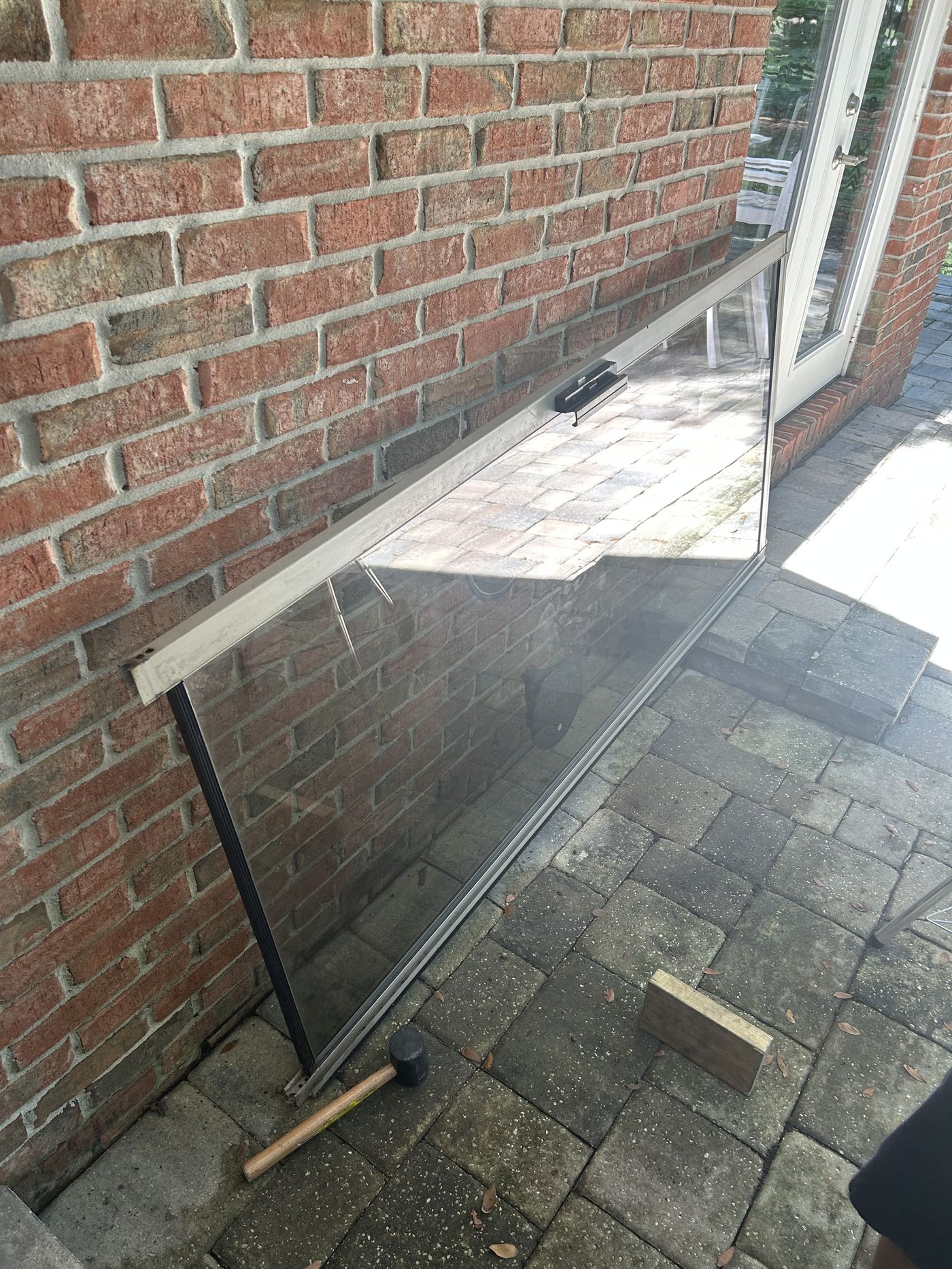 Removed sliding door glass panel during a repair