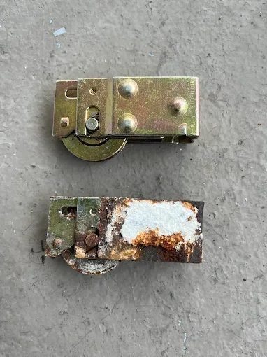 Rusted, worn sliding door rollers