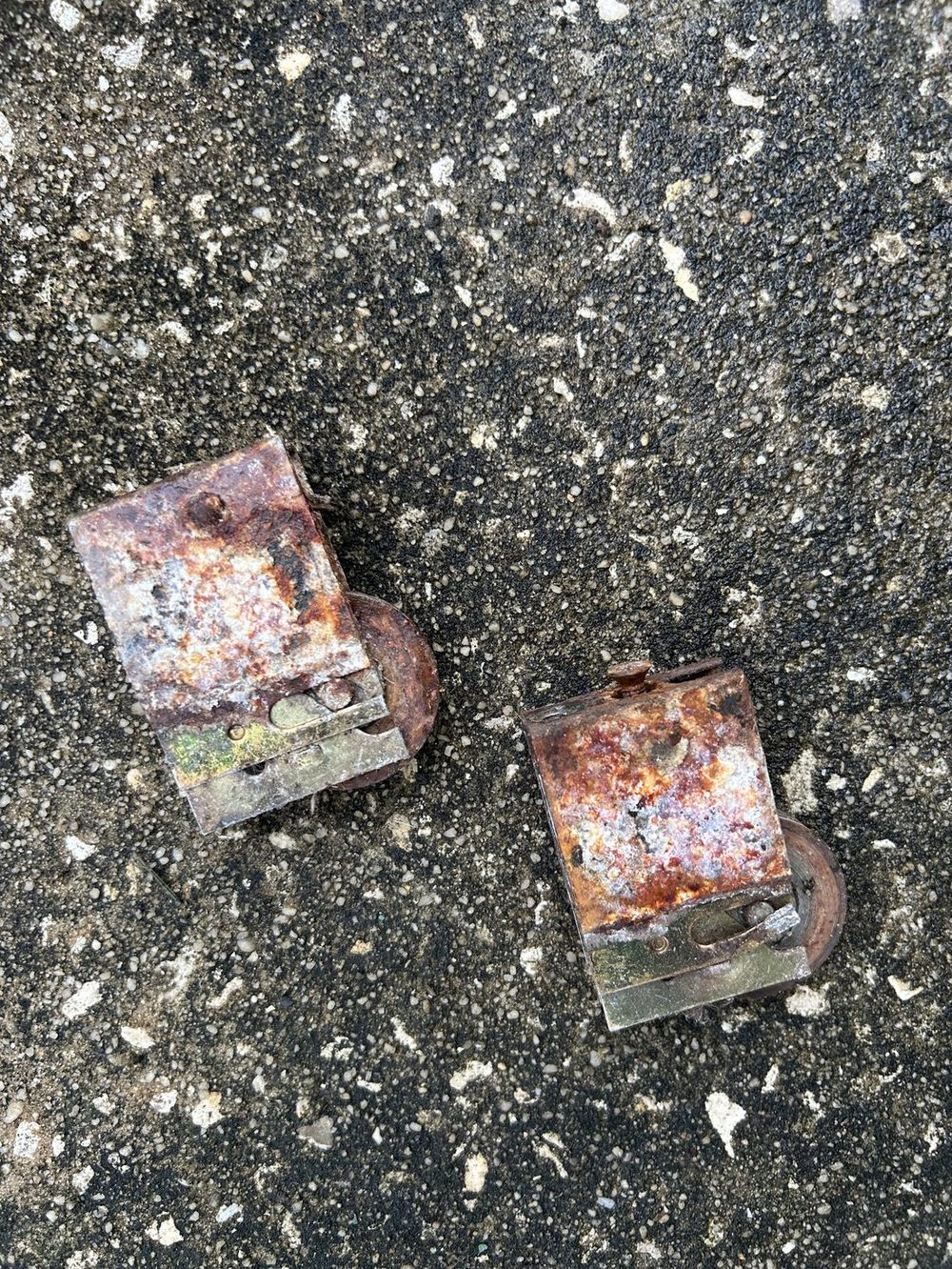 Corroded sliding door rollers removed from a door